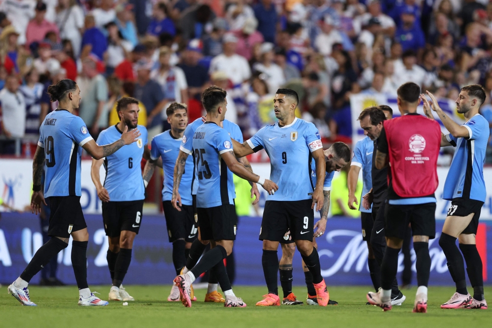 Luis Suarez of Uruguay and Cristian Olivera of Uruguay celebrate the team's victory after the CONMEBOL Copa America 2024 Group C match between United States and Uruguay on July 01, 2024 in Kansas City, Missouri. Jamie Squire/Getty Images/AFP 