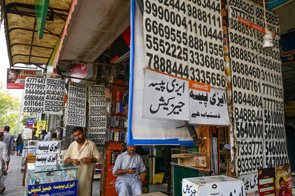Shopkeepers sell sim cards at a mobile market in Islamabad on July 4, 2024.  (Photo by Farooq Naeem / AFP)