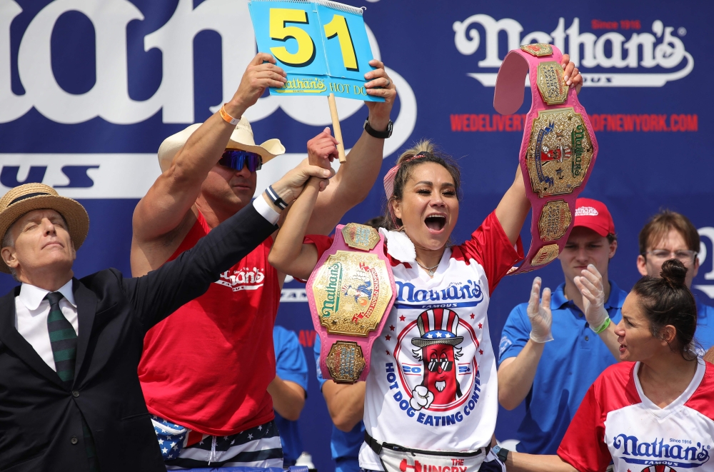 Miki Sudo celebrates after winning the women's title during the 2024 Nathan's Famous Fourth of July hot dog eating competition at Coney Island in the Brooklyn borough of New York on July 4, 2024. Sudo won after consuming a record-breaking 51 hotdogs. (Photo by Leonardo Munoz / AFP)
