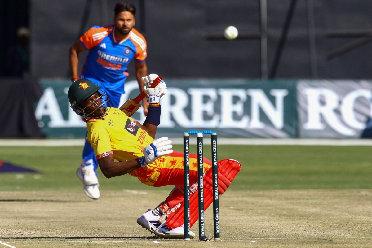 Zimbabwe's Clive Madande (front) ducks under a bouncer ball delivered by India's Mukesh Kumar (back) during the first T20 international cricket match between Zimbabwe and India at Harare Sports Club in Harare on July 6, 2024. (Photo by Jekesai NJIKIZANA / AFP)