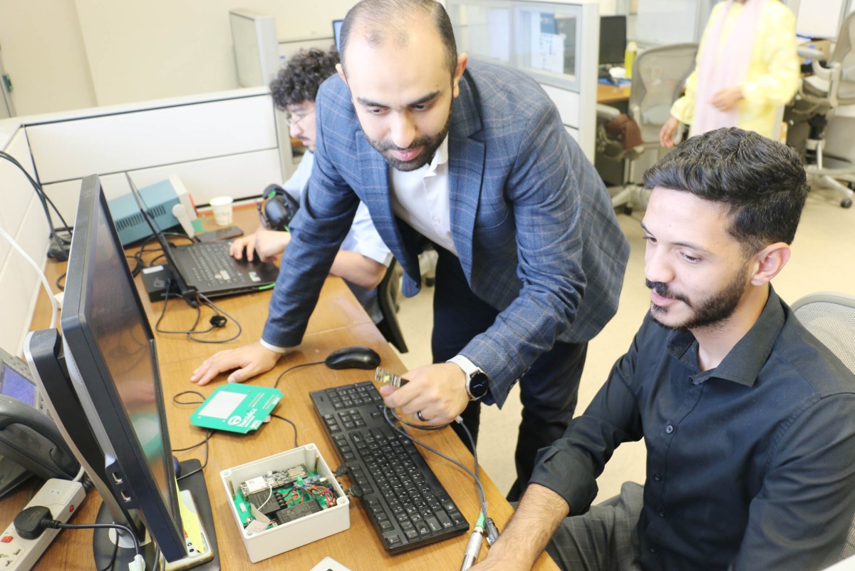 QMIC official interacting with one of the interns.