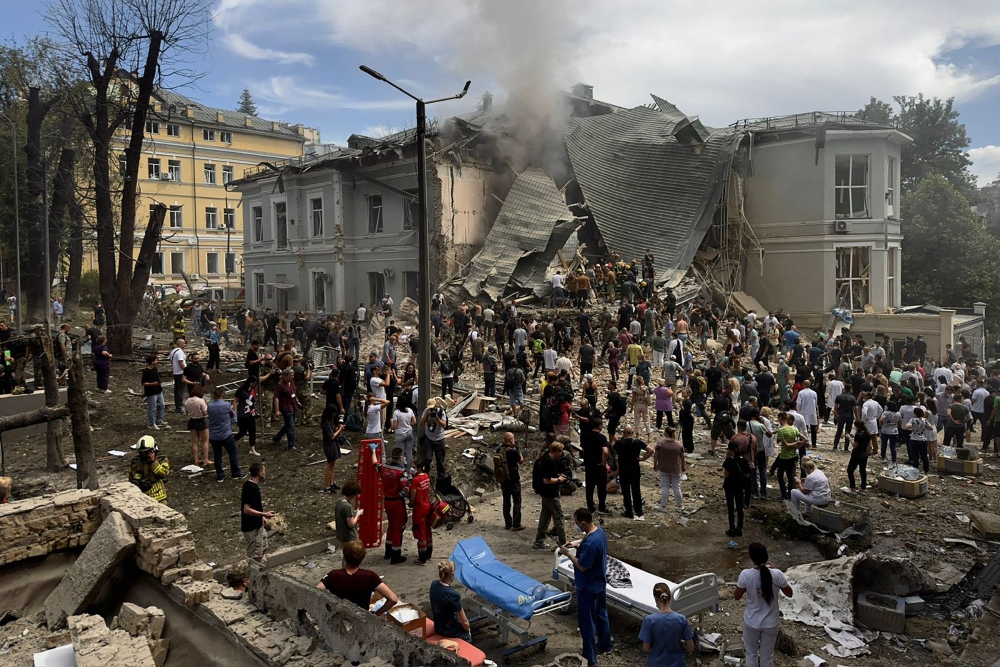 Rescuers clear the rubble of the destroyed Ohmatdyt Children's Hospital following a missile attack in Kyiv on July 8, 2024. (Photo by Roman Pilipey / AFP)