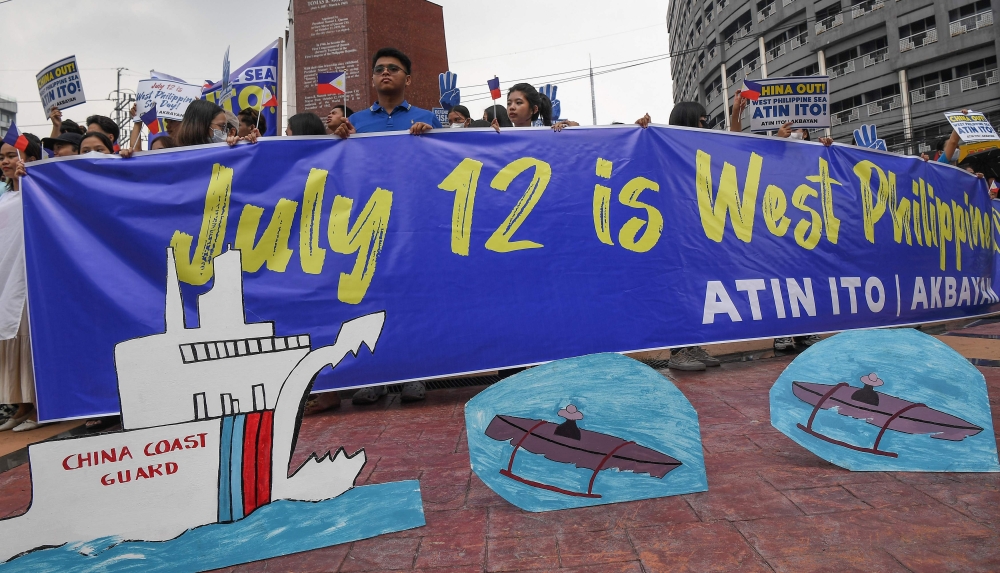 Protesters take part in a rally to mark the anniversary of the 2016 arbitral ruling on the South China Sea, at a park in Manila on July 12, 2024. (Photo by Ted Aljibe / AFP)

