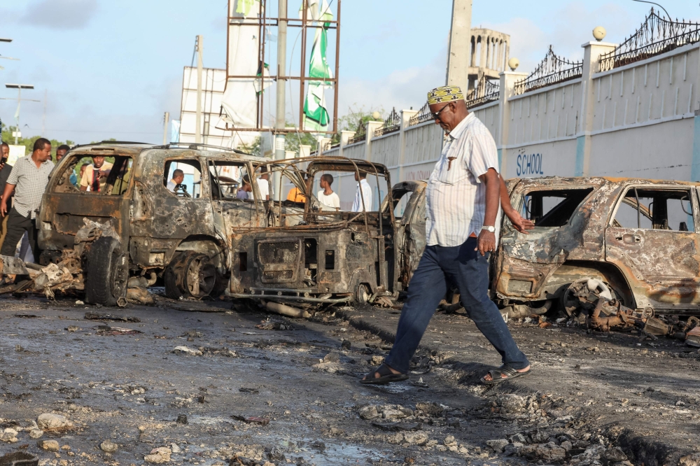 A man looks at the debris and destruction at a cafe in Mogadishu on July 15, 2024 following a car bomb blast on July 14, 2024. (Photo by Hassan Ali Elmi / AFP)
 