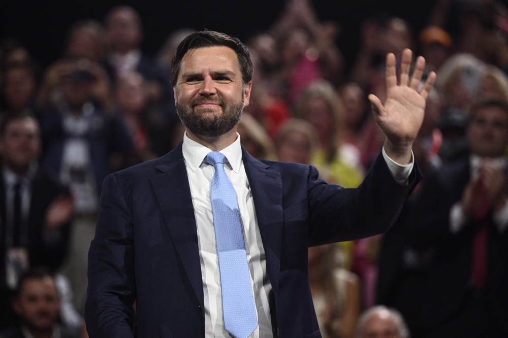 US Senator from Ohio and 2024 Republican vice-president candidate JD Vance waves during the first day of the 2024 Republican National Convention at the Fiserv Forum in Milwaukee, Wisconsin, July 15, 2024. (Photo by Brendan Smialowski / AFP)