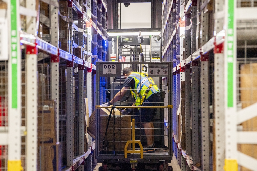 Workers fulfill orders at an Amazon fulfillment center in Melville, New York. (Photo by Johnny Milano/Bloomberg)