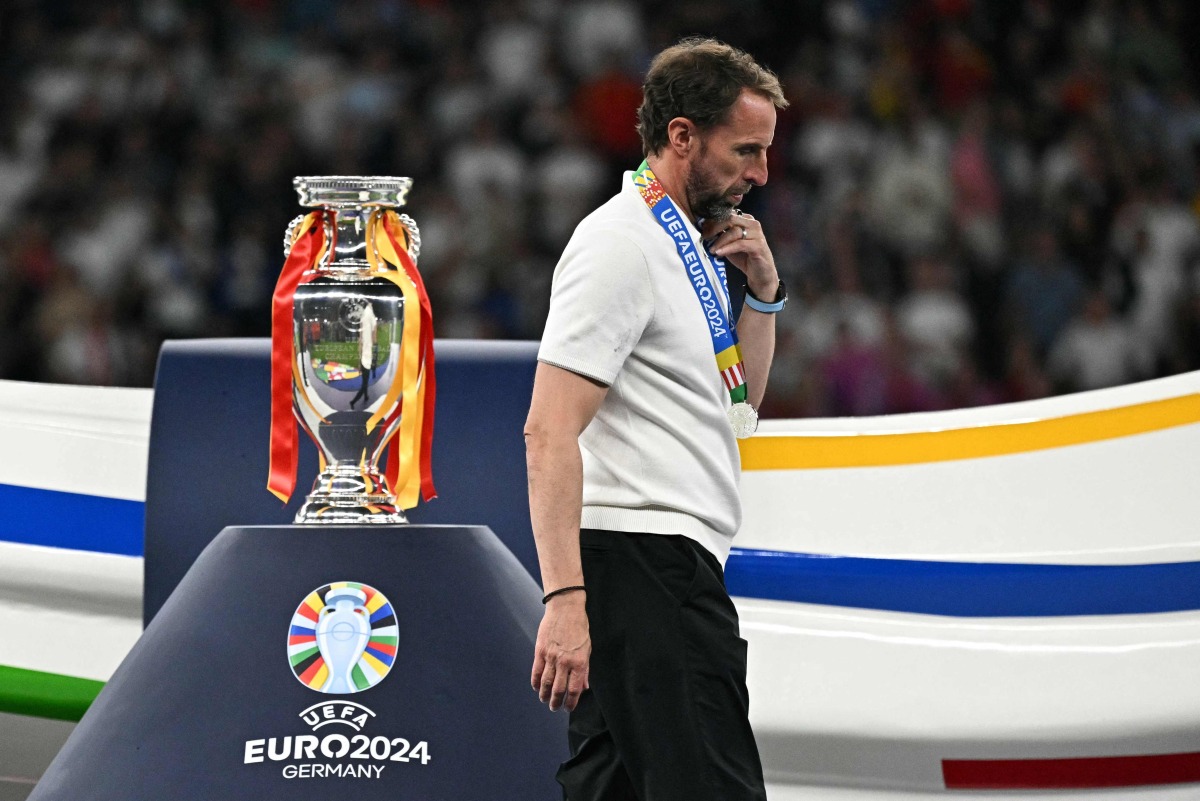 (FILES) England's head coach Gareth Southgate walks with his silver medal past to the trophy after the UEFA Euro 2024 final football match between Spain and England at the Olympiastadion in Berlin on July 14, 2024. (Photo by JAVIER SORIANO / AFP)

