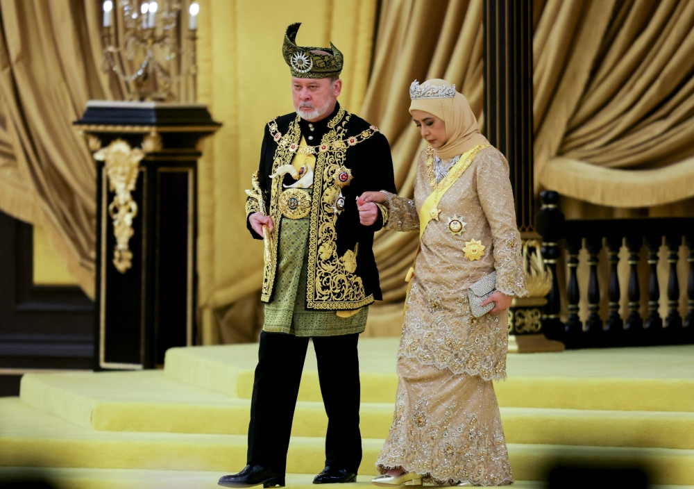 The seventeenth King of Malaysia, Sultan Ibrahim Sultan Iskandar and Queen Raja Zarith Sofiah Idris Shah walk near the throne during his coronation at the National Palace in Kuala Lumpur on July 20, 2024. (Photo by Hasnoor Hussain / Pool / AFP)