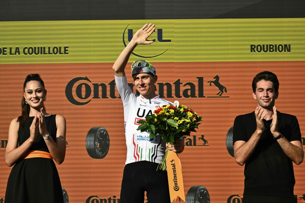 UAE Team Emirates team's Slovenian rider Tadej Pogacar celebrates on the podium after winning the 20th stage of the 111th edition of the Tour de France cycling race, 132,8 km between Nice and Col de la Couillole, southeastern France, on July 20, 2024. (Photo by Marco BERTORELLO / AFP)
