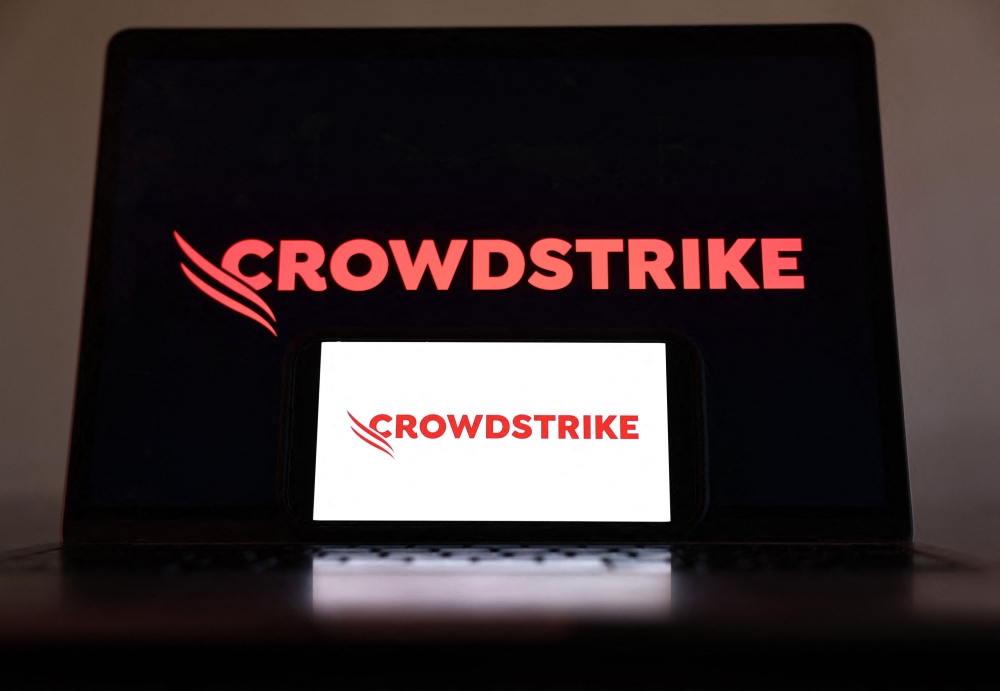 In this photo illustration, the CrowdStrike logo is displayed on a cell phone and computer monitor on July 19, 2024 in Los Angeles, California. (Photo Illustration by Mario Tama/Getty Images) 