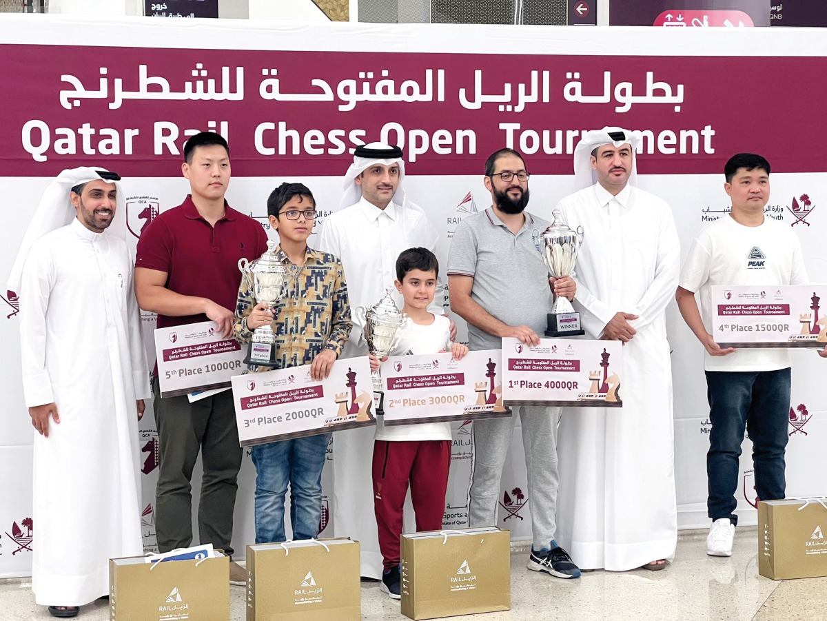 The podium winners pose for a photo with officials.