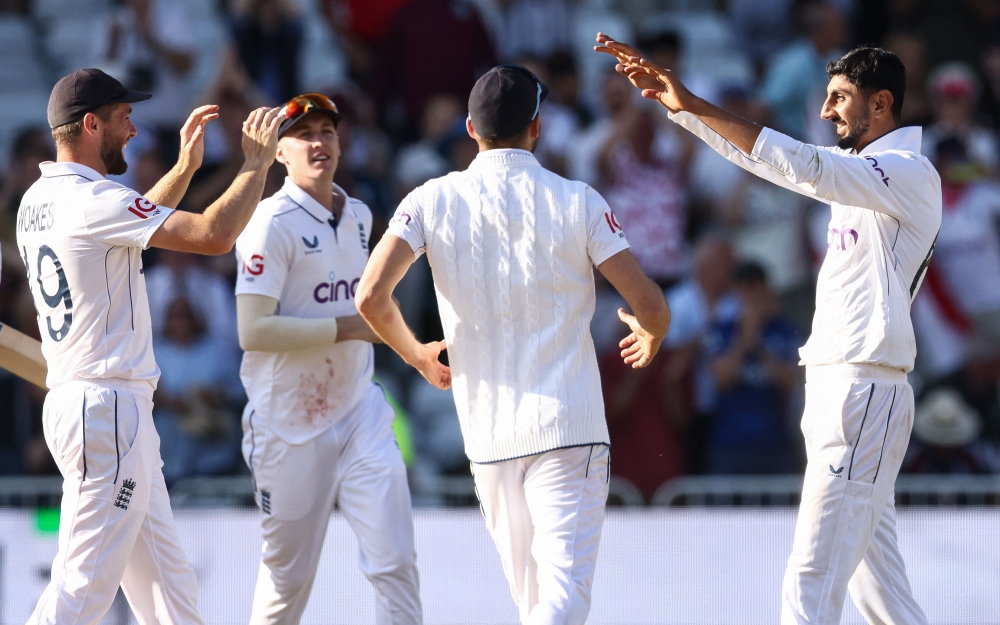 England's Shoaib Bashir (R) celebrates with teammates after taking the last wicket of West Indies Shamar Joseph to win the second Test cricket match between England and West Indies at Trent Bridge in Nottingham on July 21, 2024. (Photo by Darren Staples / AFP)