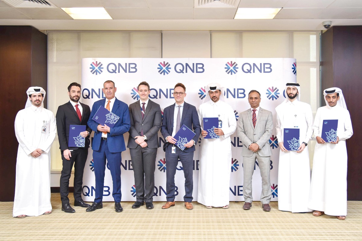 QNB and Chartered Institute of Marketing officials pose for a group photo.