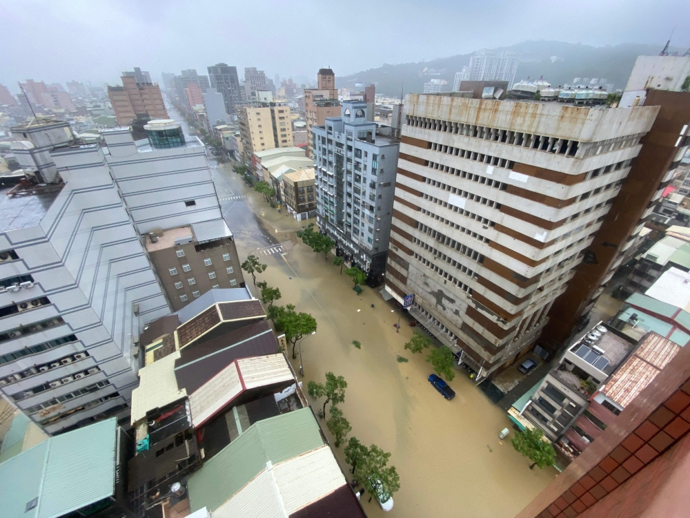 This photo taken and released by Taiwan's Central News Agency (CNA) on July 25, 2024 shows a general view of a flooded street caused by heavy rains brought by Typhoon Gaemi in Kaohsiung. (Photo by CNA / AFP) 