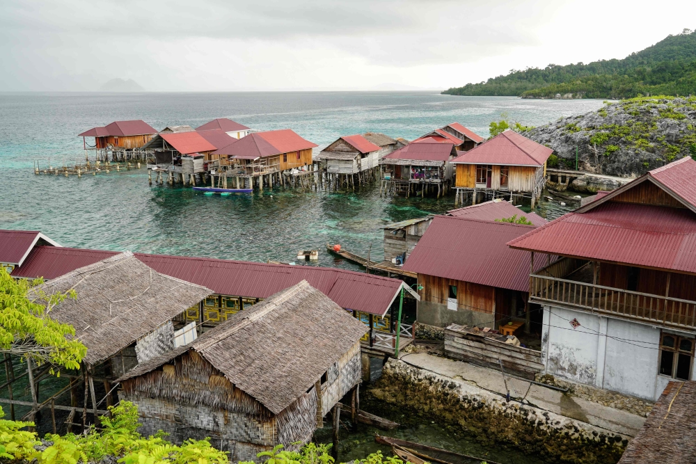 This photo taken on July 5, 2024 shows a general view of stilt houses at the village of the Bajau sea nomads in Pulau Papan in Sulawesi. (Photo by Jack Moore / AFP) 