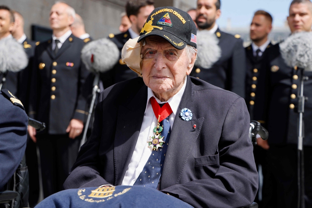 (FILES) French WWII veteran Jacques Levis, who landed on Utah beach on D-Day alongside US troops, waits for the arrival of US President ahead of a ceremony as part of his state visit to France, at the Arc de Triomphe in Paris on June 8, 2024. (Photo by Ludovic MARIN / POOL / AFP)
