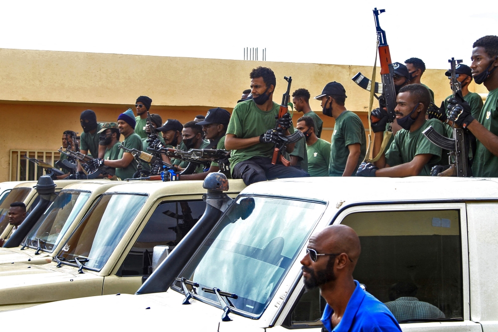 Members of a 'joint security cell' made up of various military and security services affiliated with Sudan's army, brandish rifles as they take part in a parade in Gedaref city in the east of the war-torn country, on July 28, 2024. (Photo by AFP)
