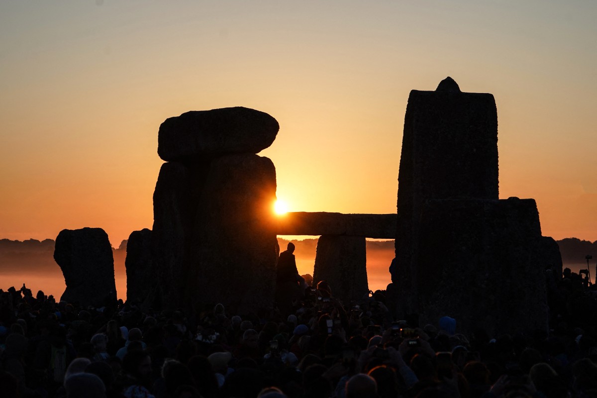 The sun rises at Stonehenge, near Amesbury, in Wiltshire, southern England on June 21, 2024, during the Summer Solstice festival, which dates back thousands of years, celebrating the longest day of the year when the sun is at its maximum elevation. Photo by William EDWARDS / AFP