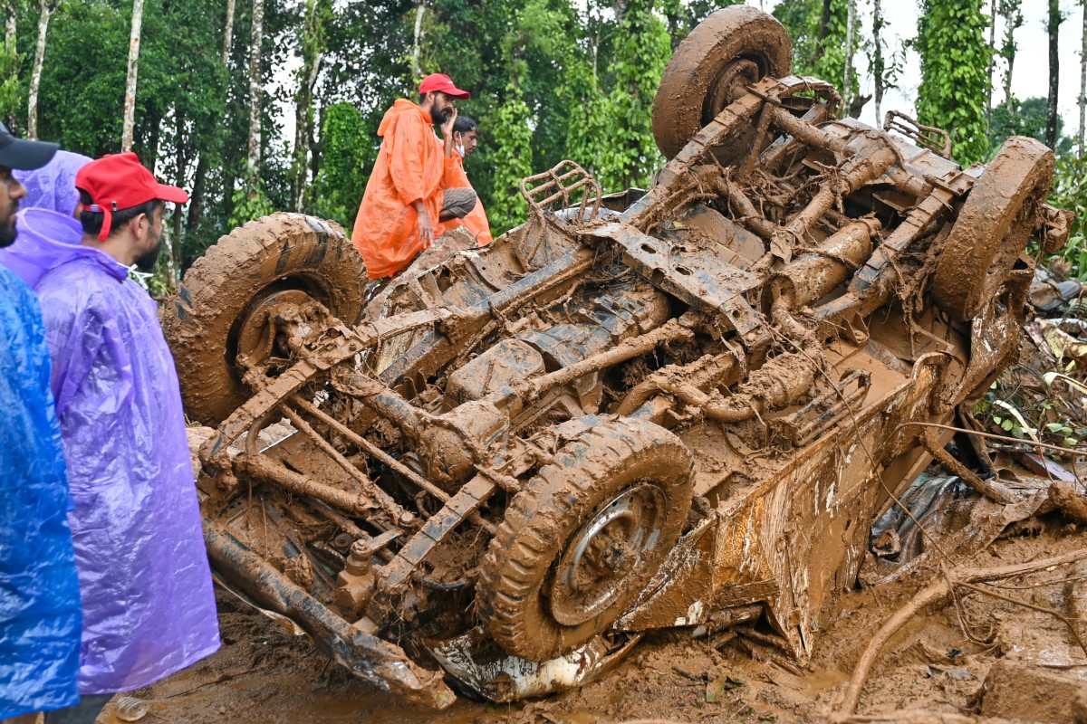 Rescue workers check a damaged vehicle after the landslides in Wayanad on August 1, 2024. Photo by Idrees MOHAMMED / AFP.
