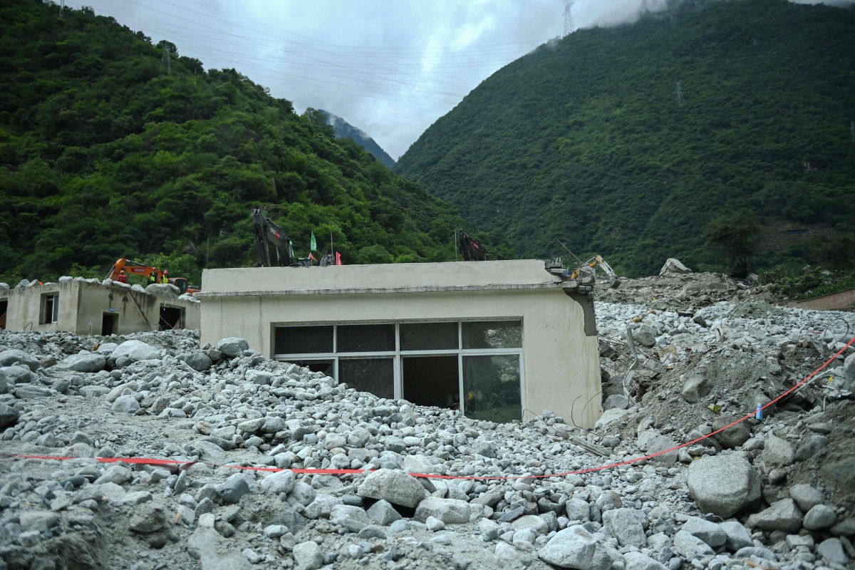 A partially buried building is pictured a day after a landslide in Kangding, in China痴 southwest Sichuan province on August 4, 2024. (Photo by CNS / CNS / AFP)