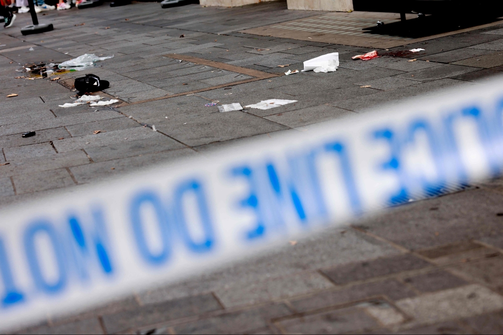 A photograph taken on August 12, 2024 shows a hat and other items in a cordoned off area in Leicester square, London. Photo by BENJAMIN CREMEL / AFP
