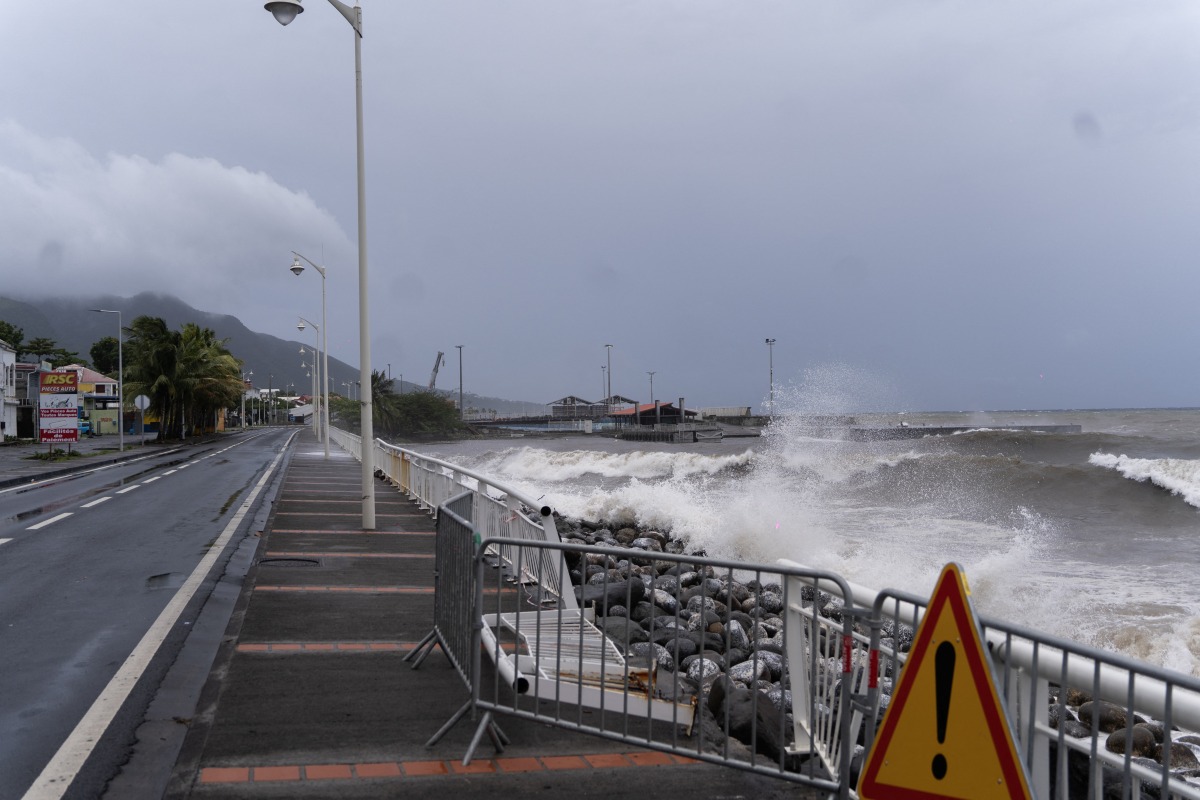 This photograph shows waves crashing against the shoreline in the aftermath of tropical storm Ernesto, in the town of Basse-Terre, on the French Caribbean island of Guadeloupe, on August 13, 2024. (Photo by Brian NOCANDY / AFP)