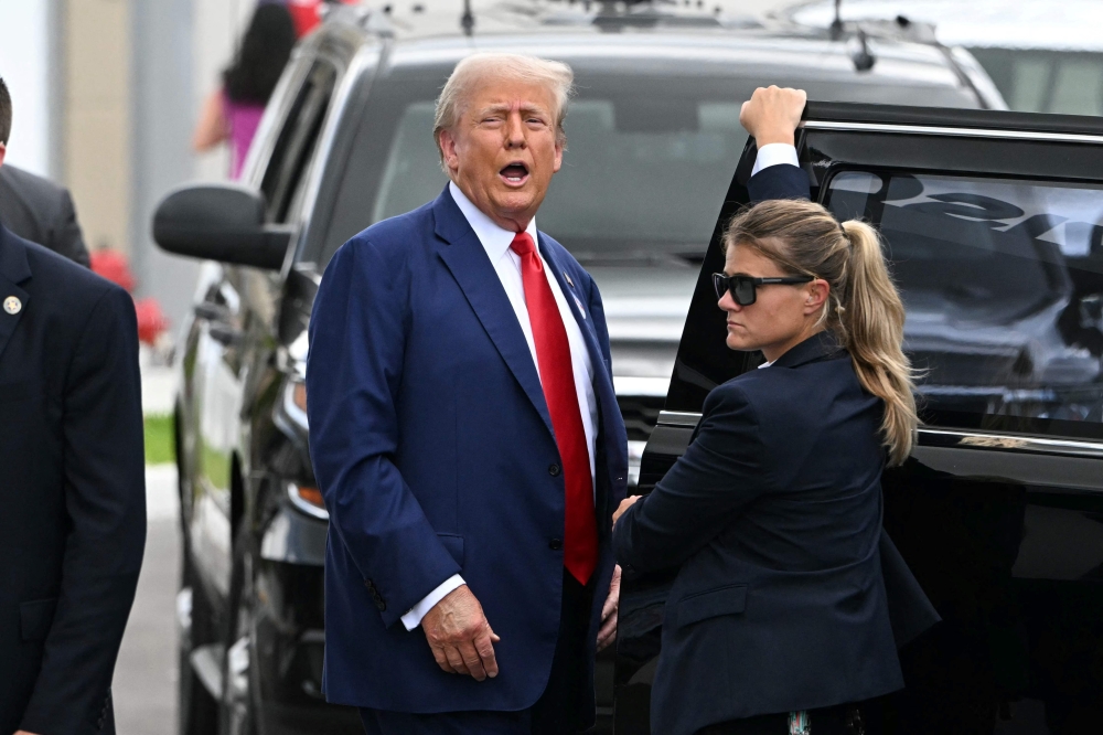 Former US President and Republican presidential candidate Donald Trump leaves after casting his vote in Florida's primary election on August 14, 2024 in West Palm Beach, Florida. (Photo by CHANDAN KHANNA / AFP)
