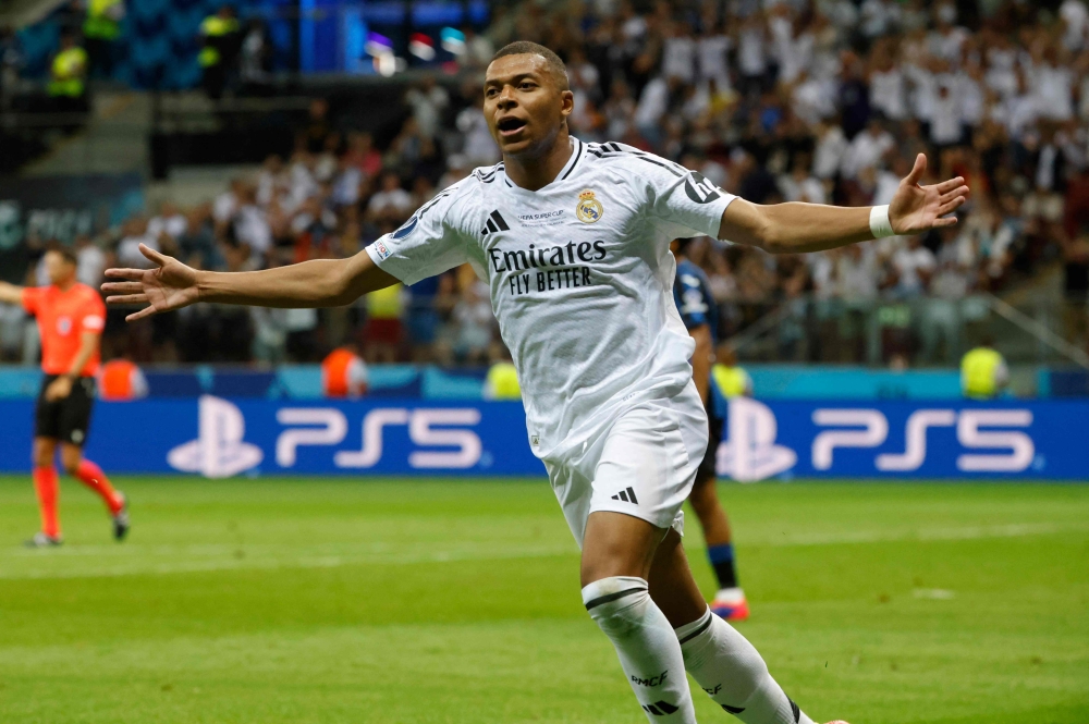 Real Madrid's French forward #09 Kylian Mbappe celebrates scoring during the UEFA Super Cup football match between Real Madrid and Atalanta BC in Warsaw, on August 14, 2024. (Photo by Wojtek Radwanski / AFP)