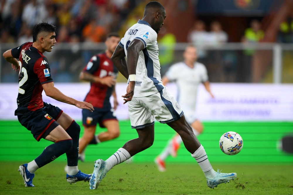 Inter Milan's French forward #09 Marcus Thuram (R) shoots to score his team's second goal during the Italian Serie A football match between Genoa and Inter Milan at the Luigi Ferraris Stadium in Genoa, on August 17, 2024. (Photo by MARCO BERTORELLO / AFP)
