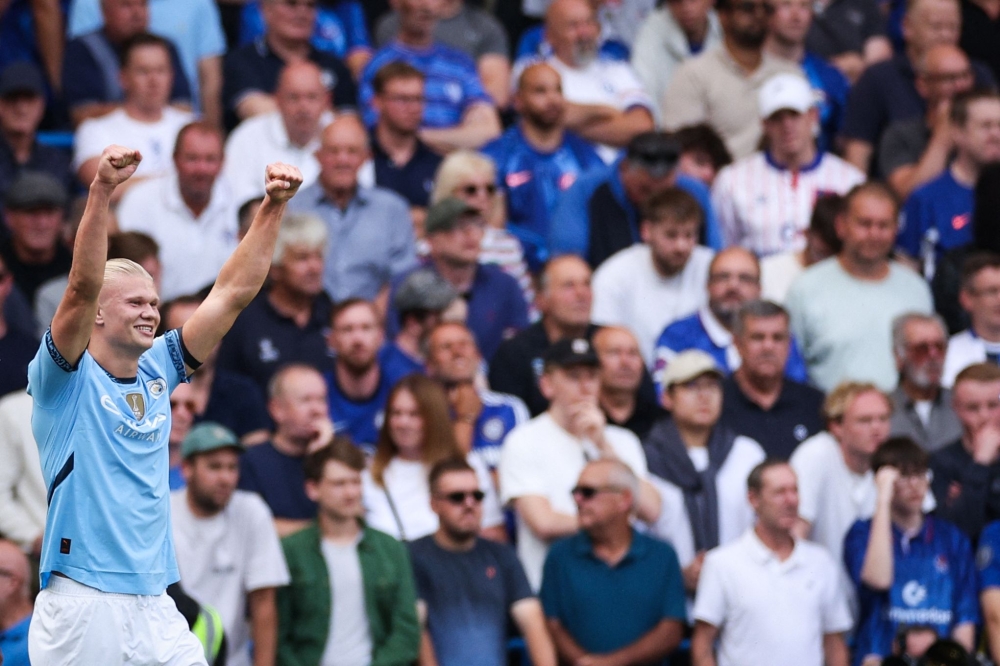 Manchester City's Norwegian striker #09 Erling Haaland celebrates after scoring his team first goal during the English Premier League football match between Chelsea and Manchester City at Stamford Bridge in London on August 18, 2024. (Photo by Adrian DENNIS / AFP)

