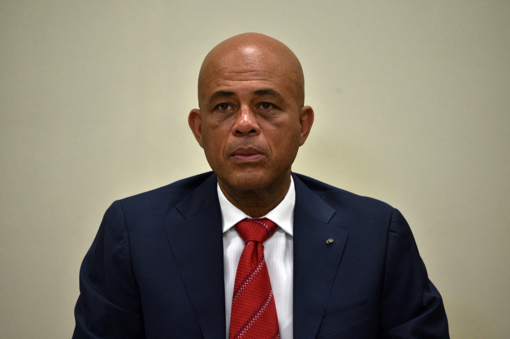 (FILES) Haitian President Michel Martelly awaits the ceremonial signing of an agreement to install a transitional government on February 6, 2016 in Port-au-Prince, Haiti. (Photo by HECTOR RETAMAL / AFP)
