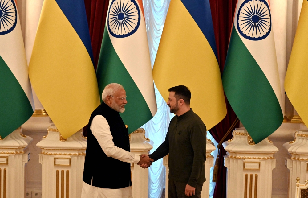 Ukrainian President Volodymyr Zelensky (R) and Indian Prime Minister Narendra Modi shake hands after their talks in Mariinskyi Palace in Kyiv, on August 23, 2024. (Photo by Sergei Supinsky / AFP)
