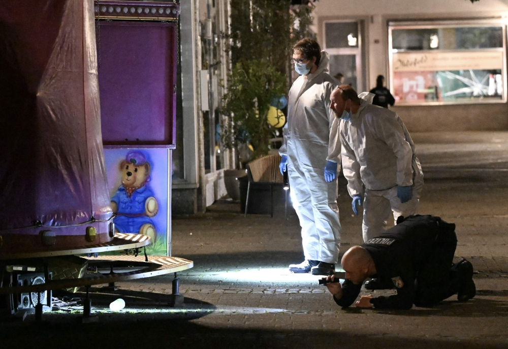 Forensic police inspect on early August 24, 2024 the area where at least three people were killed and several injured when a man attacked them with a knife on late August 23, 2024 in Solingen, western Germany, according to German media, as the city celebrated its 650th anniversary. (Photo by INA FASSBENDER / AFP) / ALTERNATE CROP