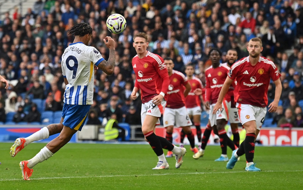 Brighton's Brazilian striker #09 Joao Pedro headers the ball to scores the team's second goal during the English Premier League football match between Brighton and Hove Albion and Manchester United at the American Express Community Stadium in Brighton, southern England on August 24, 2024. (Photo by Glyn KIRK / AFP) /