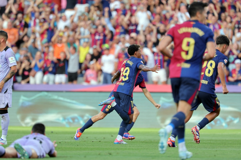 Barcelona's Spanish forward #19 Lamine Yamal celebrates scoring the opening goal during the Spanish league football match between FC Barcelona and Athletic Club Bilbao at the Estadi Olimpic Lluis Companys in Barcelona on August 24, 2024. (Photo by LLUIS GENE / AFP)
