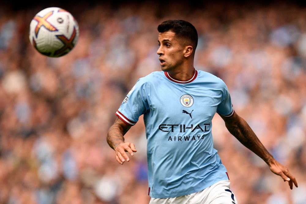 (FILES) Manchester City's Portuguese defender Joao Cancelo controls the ball during the English Premier League football match between Manchester City and Southampton at the Etihad Stadium in Manchester, north west England, on October 8, 2022. (Photo by Oli SCARFF / AFP) 