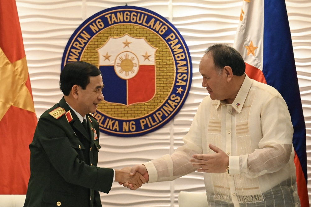 Vietnam's Minister of Defence General Phan Van Giang (left) and Philippines' Defence Secretary Gilberto Teodoro after delivering their joint statements at the Department of National Defense office in Manila on August 30, 2024. (Photo by Ted Aljibe / AFP)