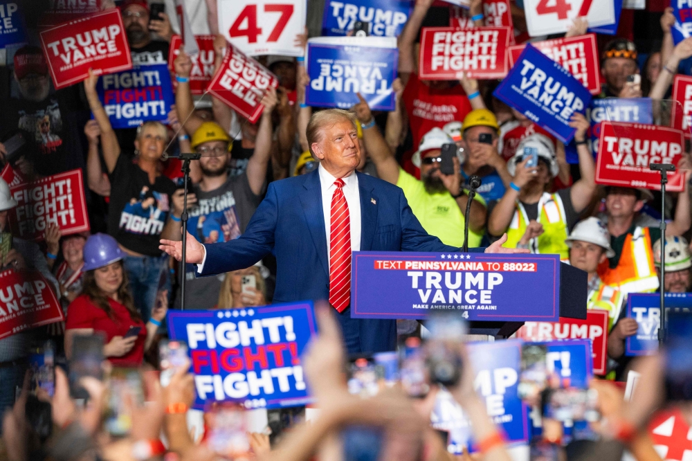 Former US President and Republican presidential candidate Donald Trump reacts as he arrives to speak at a rally at 1st Summit Arena at the Cambria County War Memorial in Johnstown, Pennsylvania, on August 30, 2024. (Photo by ROBERTO SCHMIDT / AFP)
