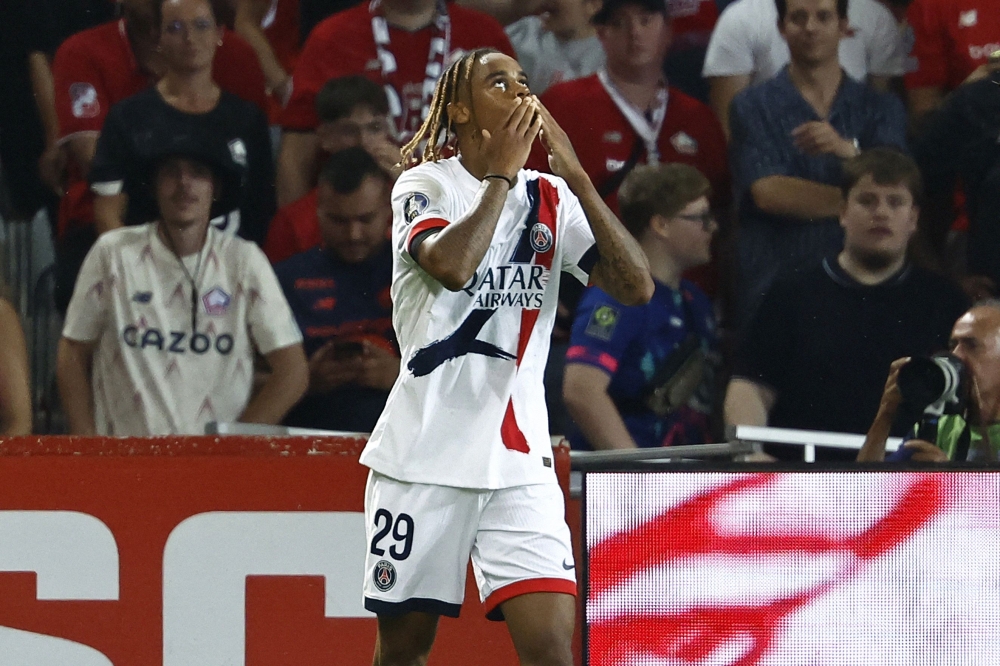 Paris Saint-Germain's French forward #29 Bradley Barcola celebrates after scoring PSG's second goal during the French L1 football match between Lille LOSC and Paris Saint-Germain (PSG) at the Stade Pierre-Mauroy in Villeneuve-d'Ascq, northern France, on September 1, 2024. (Photo by DENIS CHARLET / AFP)
