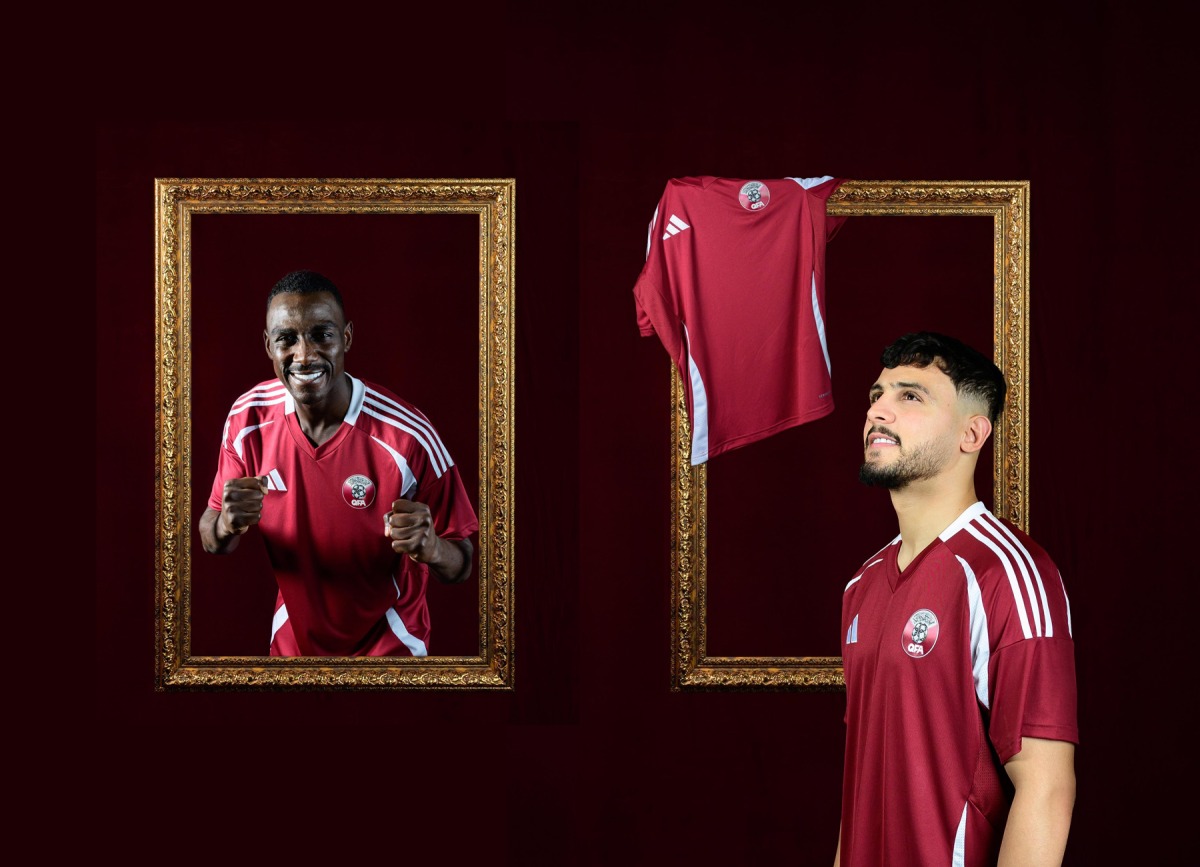 Qatar's Almoez Ali (left) and Bassam Al Rawi pose for photos sporting new national team's kit unveiled by the Qatar Football Association yesterday ahead of the third round of FIFA World Cup 2026 Qualifiers.    