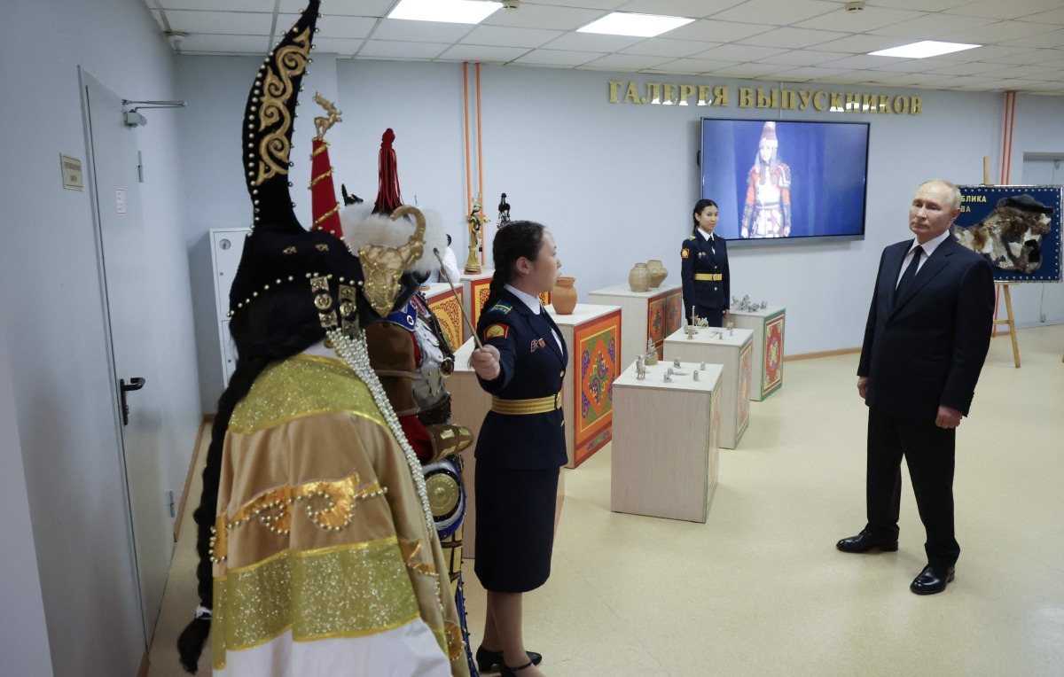 In this pool photograph distributed by the Russian state agency Sputnik, Russia's President Vladimir Putin visits the Kyzyl Presidential Cadet School in Kyzyl on September 2, 2024, on the first day of the new school year, known as the Knowledge Day. (Photo by Vyacheslav PROKOFYEV / POOL / AFP)