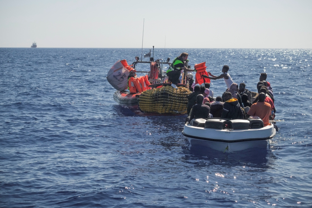 File photo: Crew members of NGO rescue ship 'Ocean Viking' give lifejackets to migrants on an overcrowded boat in the Mediterranean Sea, on October 25, 2022. Camille Martin Juan/Sos Mediterranee/Handout via REUTERS


