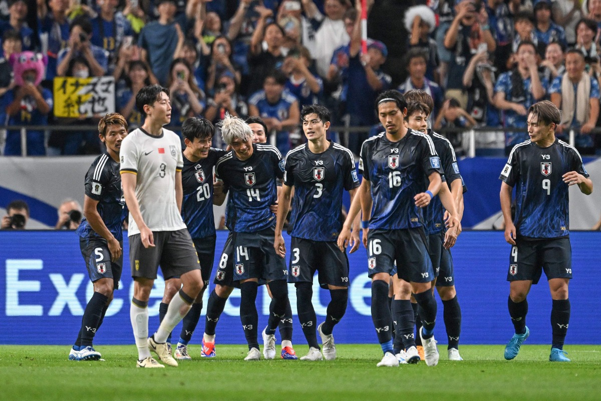 Japan's midfielder Junya Ito (4th L-#14) celebrates with teammates after scoring the team's fifth goal during the third round 2026 World Cup qualifying round football match between Japan and China at Saitama Stadium in Saitama, north of Tokyo, on September 5, 2024. (Photo by Yuichi YAMAZAKI / AFP)
