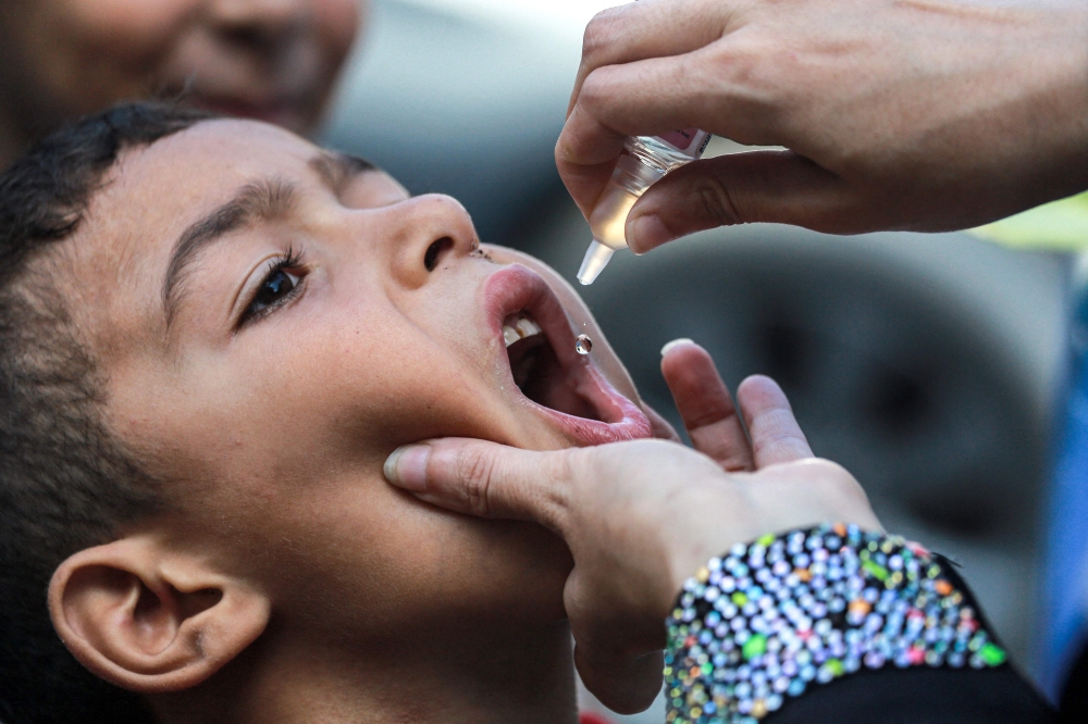 A child receives a vaccination for polio in Khan Yunis in the southern Gaza Strip on September 5, 2024. Photo by Bashar TALEB / AFP