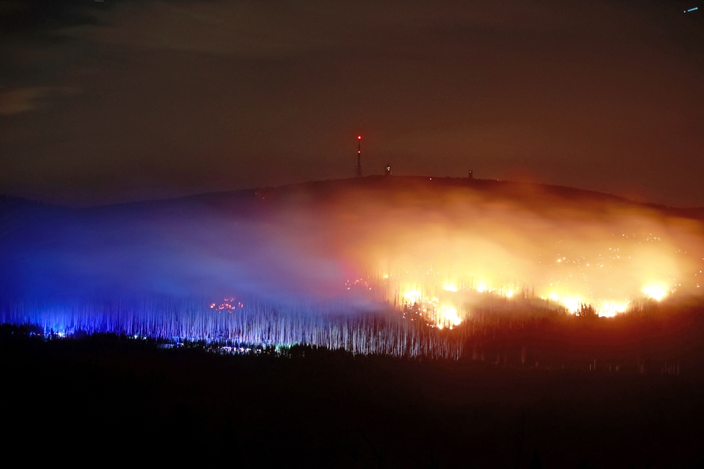 Flames and embers are seen on the Koenigsberg below the Brocken, the highest point of the Harz Mountains, in Wernigerode, Saxony-Anhalt, on September 6, 2024. (Photo by Matthias Bein / dpa / AFP) 
 