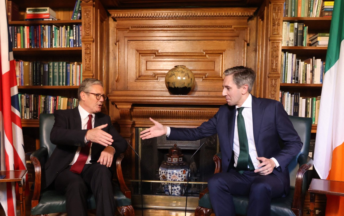 Ireland's Prime Minister Simon Harris (R) and Britain's Prime Minister Keir Starmer shake hands as they pose for a photograph inside Farmleigh House in Dublin on September 7, 2024, during their meeting. (Photo by Peter Morrison / POOL / AFP)
