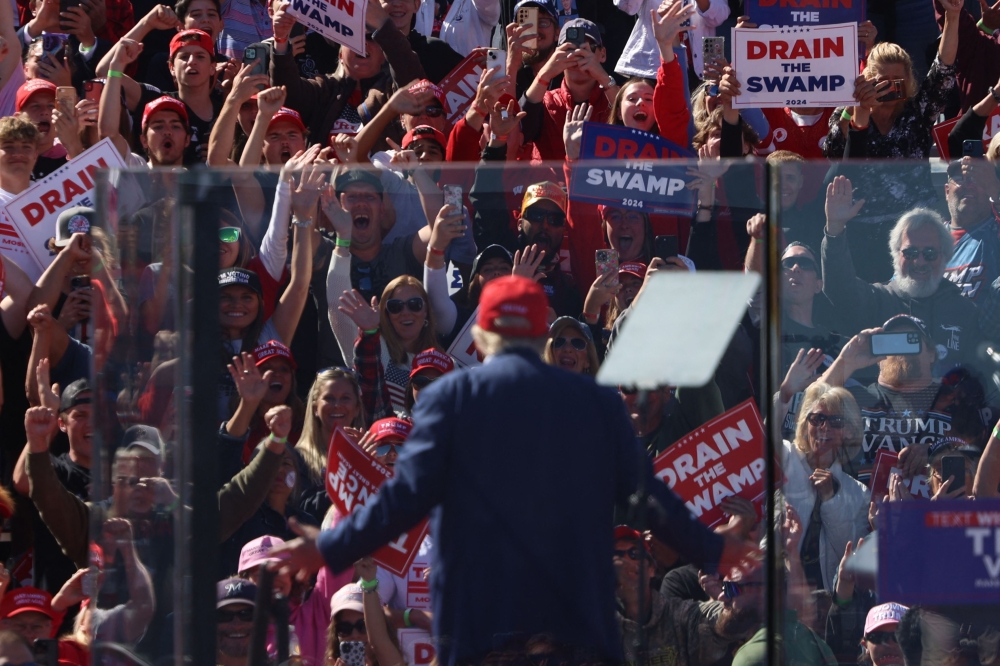 Supporters cheer as Former US President and 2024 Republican presidential candidate Donald Trump speaks during a rally at the Central Wisconsin Airport in Mosinee, Wisconsin, on September 7, 2024. (Photo by Alex Wroblewski / AFP)