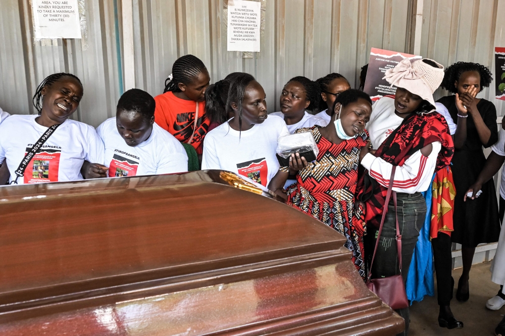 Friends and family react as they view the body of late marathon runner Rebecca Cheptegei in Eldoret, western Kenya, on September 13, 2024. (Photo by Brian Ongoro / AFP)
 