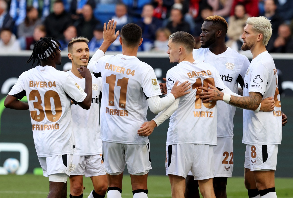 Bayer Leverkusen's Dutch defender #30 Jeremie Frimpong, Bayer Leverkusen's Spanish defender #20 Alejandro Grimaldo, Bayer Leverkusen's French forward #11 Martin Terrier, Bayer Leverkusen's German midfielder #10 Florian Wirtz, Bayer Leverkusen's Nigerian forward #22 Victor Boniface and Bayer Leverkusen's German midfielder #08 Robert Andrich celebrate after Boniface scored the 1-4 goal during the German first division Bundesliga football match between Hoffenheim and Bayer Leverkusen in Sinsheim, southwestern Germany, on September 14, 2024. (Photo by Daniel ROLAND / AFP) /