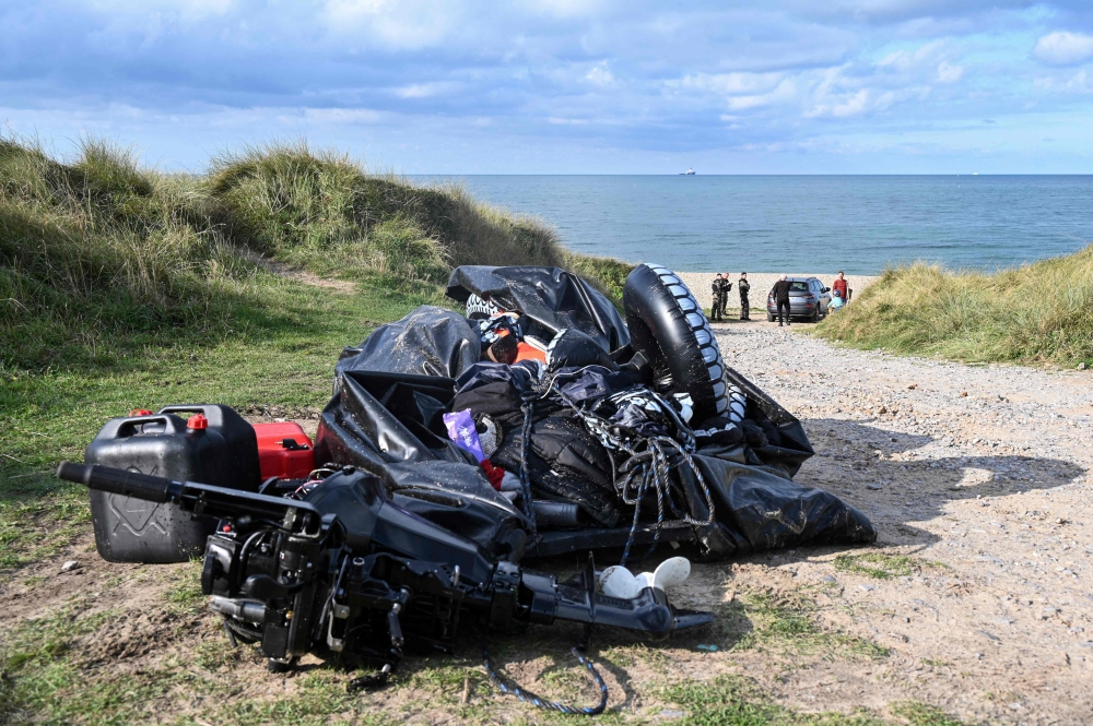 A damaged migrants' boat after a failed attempt to cross the English Channel that led to the death of 8 people near the beach of Ambleteuse, northern France. (Photo by Bernard Barron / AFP)
 